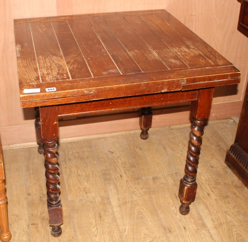 A 1920s oak draw leaf dining table, top 76cm sq. H.75cm